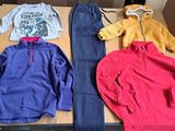 three pairs of clothes laid out on a table