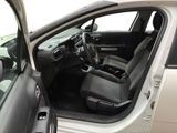 the interior of a car with the door open and the driver ' s seat down