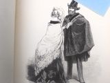 un vieux livre sur lequel figure le dessin d'un homme et d'une femme