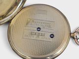 a close up of a pocket watch with a keychain