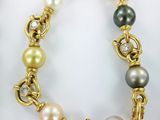 a close up of a bracelet with pearls and diamonds