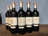 six bottles of wine sitting on top of a wooden table
