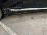 a picture of a black car parked in a parking lot