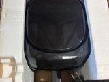 a box that has a black electronic device inside of it