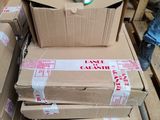 a stack of boxes and a spool of thread on a pallet