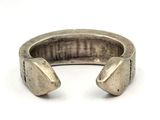 a close up of a silver ring on a white surface