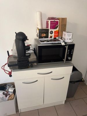 a microwave and a coffee maker sitting on top of a kitchen counter
