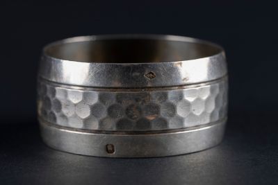 a close up of a ring on a table with a black background