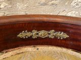 a close up of a wooden chair with a yellow cushion