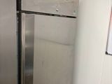 a stainless steel refrigerator in the corner of a kitchen