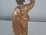 a statue of a man holding a bird in his hand