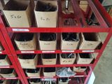 many boxes of assorted items on a red shelf