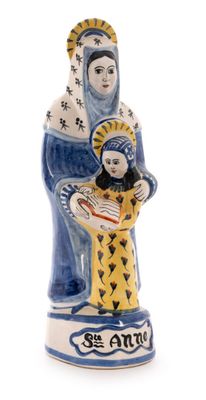 the figurine of the virgin and child is holding a fish