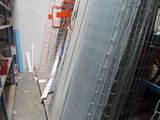 a man standing on a ladder next to a building