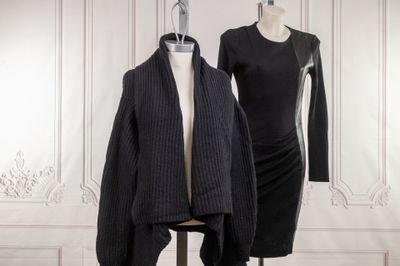 two mannequins and a dress on a mannequin stand in front of a white wall