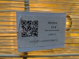 a qr code on a piece of paper attached to a wire fence