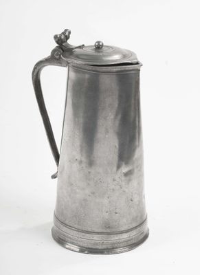 a silver pitcher with a handle on a white background