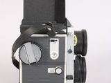 a black and white photo of a camera on a white surface