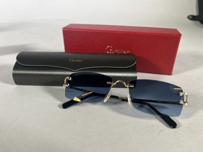 cartier sunglasses in black and gold with a red box