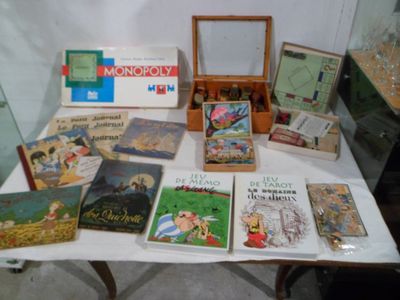 a lot of books on a table with a picture frame