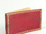 leather wallet with a red cover and gold trim