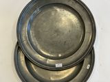 three metal plates sitting on top of each other on a white surface