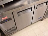 stainless steel counter top with two freezers and a counter top with two doors