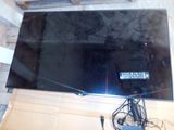 a flat screen tv sitting on top of a wooden table