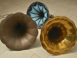 three old phonons sitting on the floor next to each other