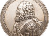 an image of a silver medal with a portrait of a man on it