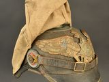 an old military hat with a feather on it on a stand