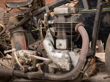 an old motorcycle that is parked on the street
