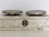 a marble box with two plates on top of it