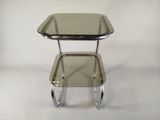 a small table with a glass top on a white background
