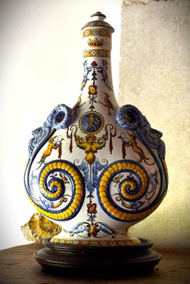 a vase that is sitting on a table in front of a wall