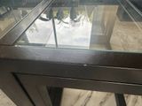 a glass table with a glass top on a marble floor
