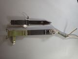 two knives that are laying on a white surface