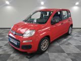 the small red car is parked on a checkered floor