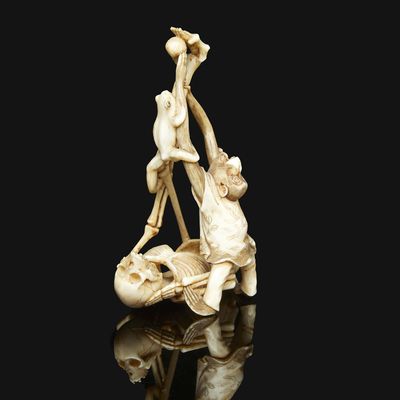an antique carved ivory figurine of a man and woman on a boat