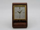 an image of a small wooden clock on a white surface