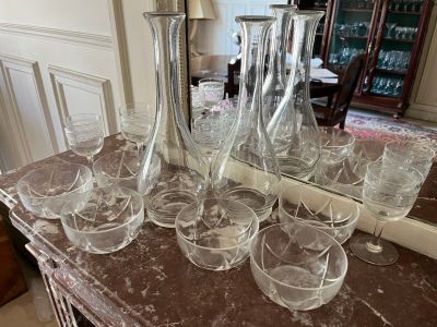 bottles and glasses on a table with a mirror in the background