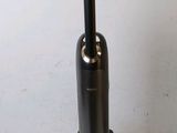 a vacuum that is sitting on a table next to a wall
