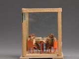 a miniature model of a table and chairs with animals in it