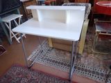 a white desk with a shelf on top of it