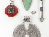 several pieces of jewelry are displayed on a white surface
