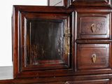 a wooden dresser with a mirror on top of it