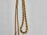 a close up of a gold chain with a tag on it