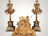 pair of antique bronze candlesticks with cherensils and figurines