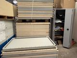 many stacks of cardboards stacked on top of each other in a warehouse