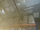 a large amount of boxes stacked on a shelf in a warehouse